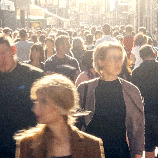 A bustling street scene with a multitude of people walking